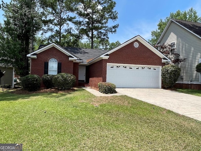 2543 Bascom Dr, Albany, GA 31707 - view of front of property featuring a garage, driveway, brick siding, and a front lawn