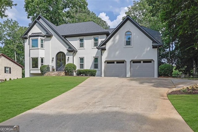525 Old Path Xing, Roswell, GA 30075 - view of front of house featuring an attached garage, driveway, stucco siding, and a front lawn