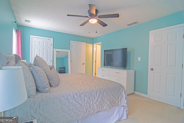 4336 Thorngate Ln, Acworth, GA 30101 - bedroom featuring light colored carpet, a ceiling fan, and two closets