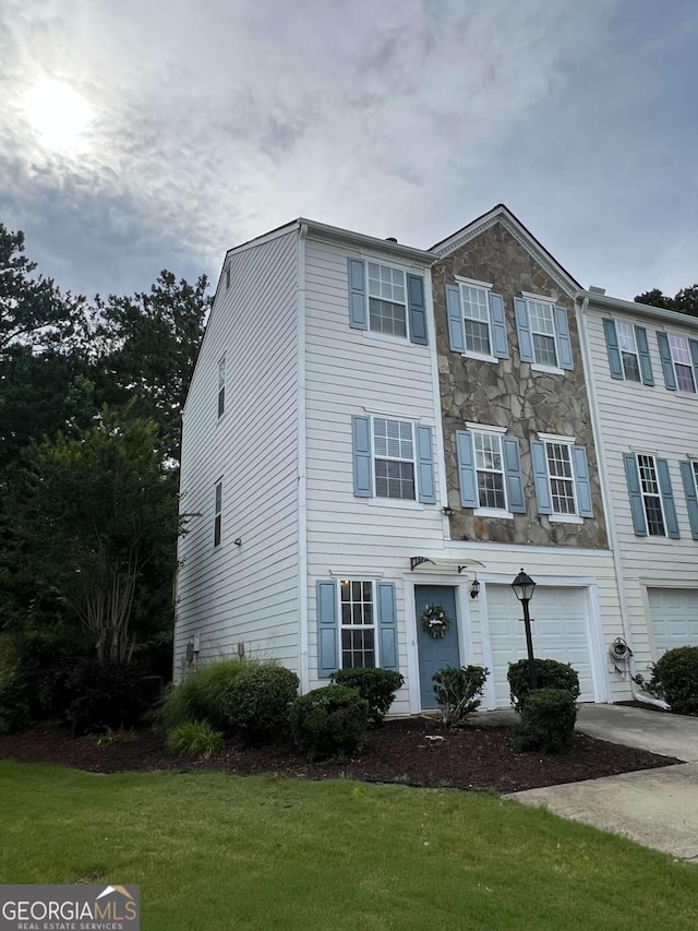 4336 Thorngate Ln, Acworth, GA 30101 - view of front of home featuring stone siding, driveway, a garage, and a front lawn