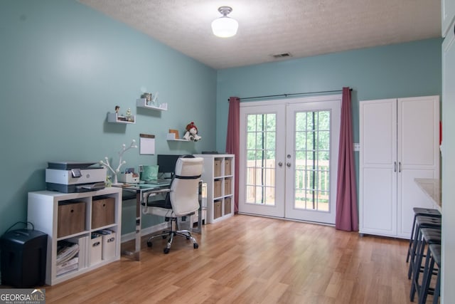 4336 Thorngate Ln, Acworth, GA 30101 - home office featuring french doors, light wood-type flooring, and a textured ceiling
