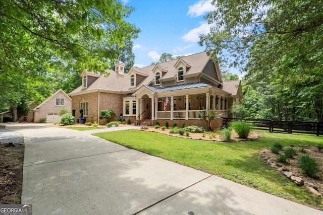 771 Rattlesnake Rdg, Dawsonville, GA 30534 - view of front of house featuring a porch, brick siding, driveway, a standing seam roof, and roof with shingles