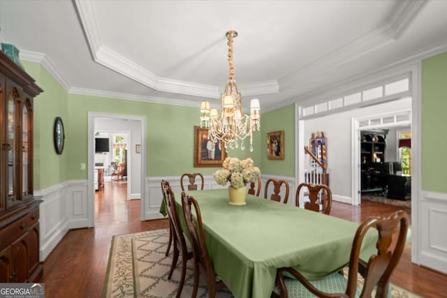 771 Rattlesnake Rdg, Dawsonville, GA 30534 - dining room featuring a tray ceiling, crown molding, a chandelier, dark wood-type flooring, and a wainscoted wall