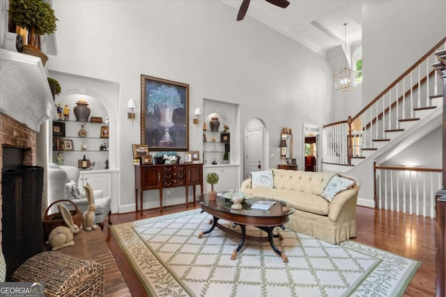 771 Rattlesnake Rdg, Dawsonville, GA 30534 - living room with a high ceiling, built in shelves, wood finished floors, a ceiling fan, and ornamental molding