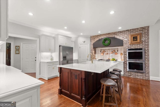 771 Rattlesnake Rdg, Dawsonville, GA 30534 - kitchen with stainless steel appliances, light countertops, wood finished floors, white cabinetry, and recessed lighting