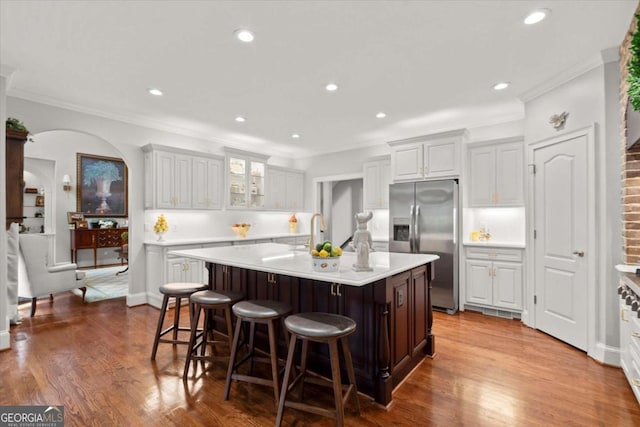 771 Rattlesnake Rdg, Dawsonville, GA 30534 - kitchen with stainless steel refrigerator with ice dispenser, ornamental molding, light countertops, a center island with sink, and a kitchen breakfast bar