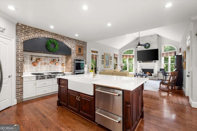 771 Rattlesnake Rdg, Dawsonville, GA 30534 - kitchen with a warm lit fireplace, appliances with stainless steel finishes, a ceiling fan, light countertops, and lofted ceiling