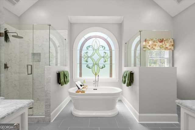 771 Rattlesnake Rdg, Dawsonville, GA 30534 - full bath with vanity, vaulted ceiling, a freestanding tub, a stall shower, and tile patterned floors