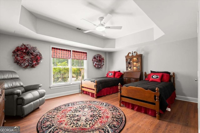 771 Rattlesnake Rdg, Dawsonville, GA 30534 - bedroom featuring a tray ceiling, wood finished floors, and a ceiling fan