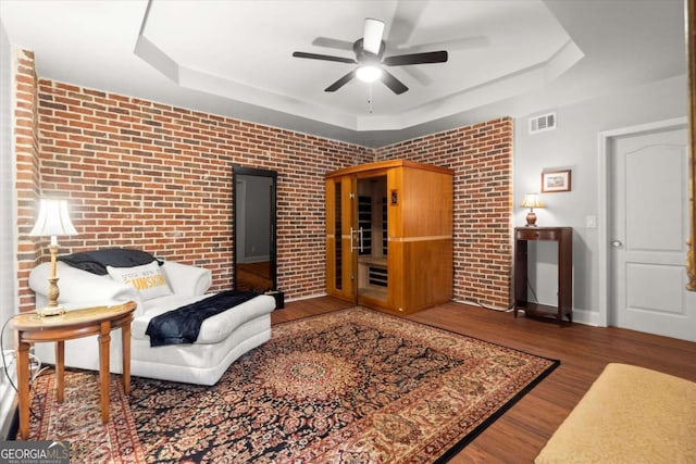 771 Rattlesnake Rdg, Dawsonville, GA 30534 - living area with a tray ceiling, wood finished floors, ceiling fan, and brick wall