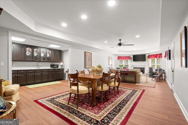 771 Rattlesnake Rdg, Dawsonville, GA 30534 - dining room featuring light wood-style flooring, ceiling fan, a fireplace, and recessed lighting