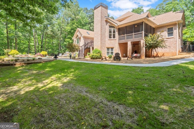 771 Rattlesnake Rdg, Dawsonville, GA 30534 - back of house featuring a sunroom, stairs, brick siding, a yard, and a chimney
