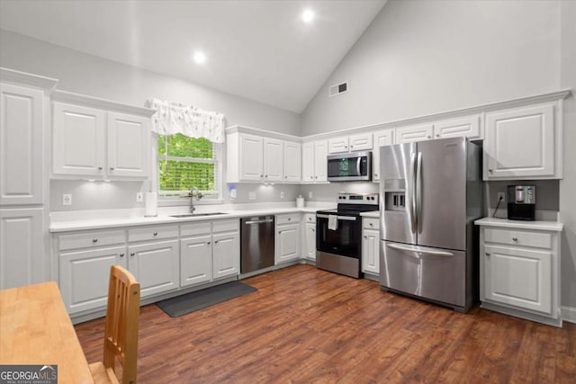 771 Rattlesnake Rdg, Dawsonville, GA 30534 - kitchen with appliances with stainless steel finishes, light countertops, white cabinetry, high vaulted ceiling, and dark wood-style floors