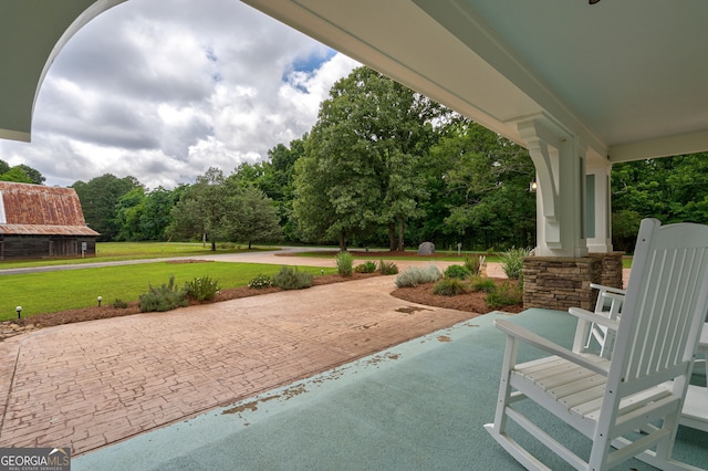 1000 Three Notch Rd, Buckhead, GA 30625 - covered porch featuring a lawn, curved driveway, and view of wooded area