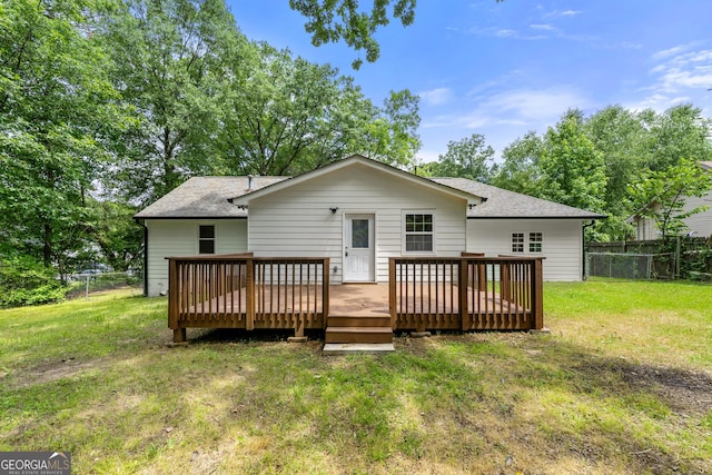 381 Warner St SE, Marietta, GA 30060 - rear view of property featuring a fenced backyard, a wooden deck, and a shingled roof
