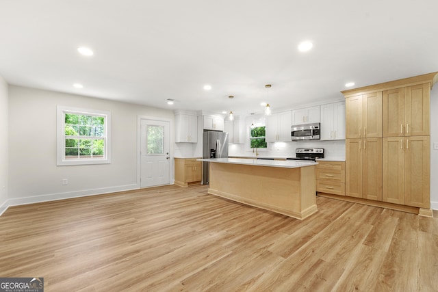 381 Warner St SE, Marietta, GA 30060 - kitchen featuring appliances with stainless steel finishes, plenty of natural light, recessed lighting, light countertops, and light wood-type flooring