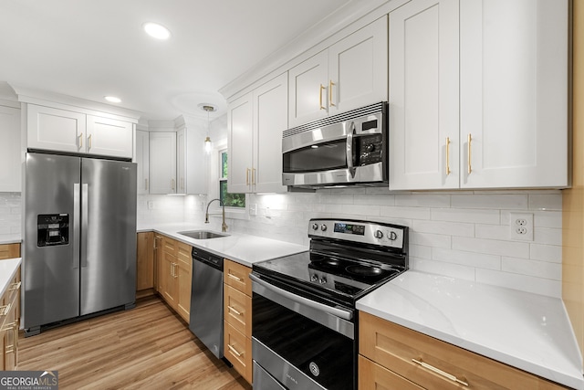 381 Warner St SE, Marietta, GA 30060 - kitchen with stainless steel appliances, decorative backsplash, light wood-style floors, white cabinets, and recessed lighting