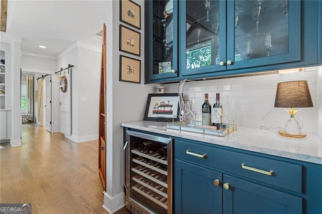 100 Yunsoo Pl E, Big Canoe, GA 30143 - indoor dry bar featuring beverage cooler, crown molding, decorative backsplash, wood finished floors, and baseboards