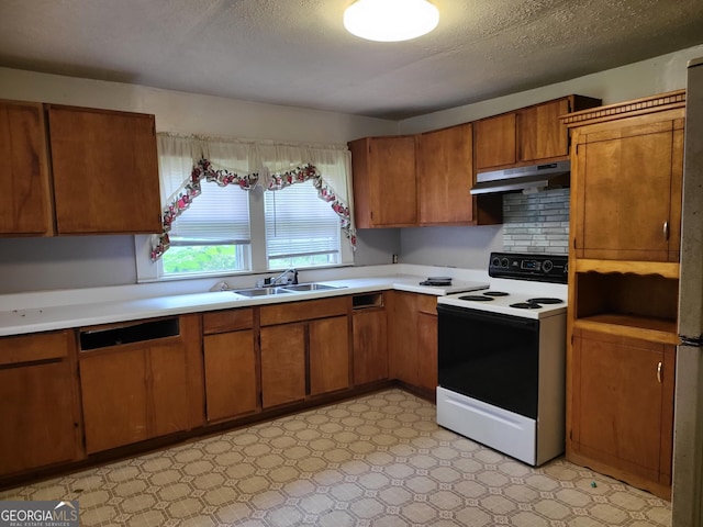 288 7th Ave, Winder, GA 30680 - kitchen with range with electric stovetop, under cabinet range hood, a sink, and light countertops