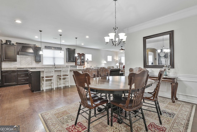 819 Firefly Ct, Griffin, GA 30223 - dining room with a chandelier, ornamental molding, recessed lighting, dark wood-type flooring, and wainscoting