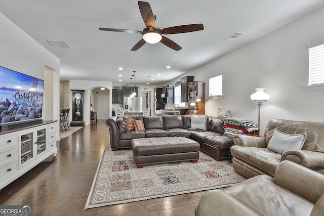 819 Firefly Ct, Griffin, GA 30223 - living area featuring a ceiling fan, arched walkways, recessed lighting, and dark wood-style flooring