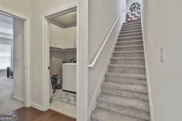 819 Firefly Ct, Griffin, GA 30223 - stairs with wood finished floors, washer / dryer, and carpet floors