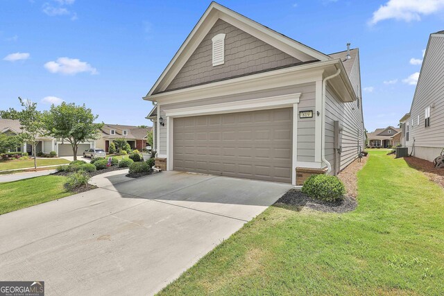 819 Firefly Ct, Griffin, GA 30223 - view of front of house featuring a garage, a front yard, driveway, and a residential view
