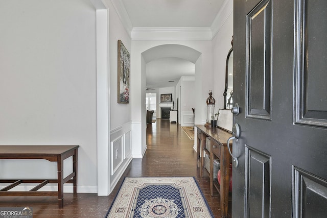 819 Firefly Ct, Griffin, GA 30223 - entryway featuring arched walkways, crown molding, wood finished floors, and a wainscoted wall