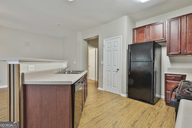 136 Granite Way, Newnan, GA 30265 - kitchen with black appliances, a sink, light wood finished floors, and reddish brown cabinets