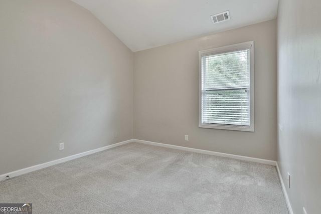 136 Granite Way, Newnan, GA 30265 - spare room featuring carpet, lofted ceiling, and baseboards