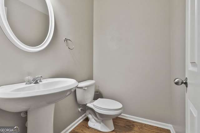 136 Granite Way, Newnan, GA 30265 - half bath with baseboards, wood finished floors, toilet, and a sink