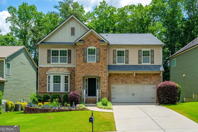 4540 Fourth Rail Ln, Cumming, GA 30040 - craftsman house with a garage, concrete driveway, board and batten siding, and a front lawn