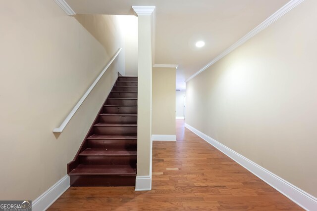 4540 Fourth Rail Ln, Cumming, GA 30040 - stairway with crown molding, wood finished floors, and recessed lighting