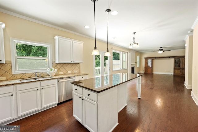 4540 Fourth Rail Ln, Cumming, GA 30040 - kitchen with stainless steel dishwasher, ornamental molding, open floor plan, ceiling fan, and tasteful backsplash