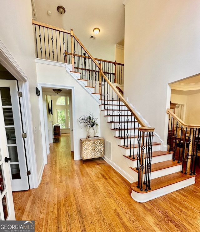 4265 Lansmoore, Suwanee, GA 30024 - stairs featuring wood finished floors and a towering ceiling