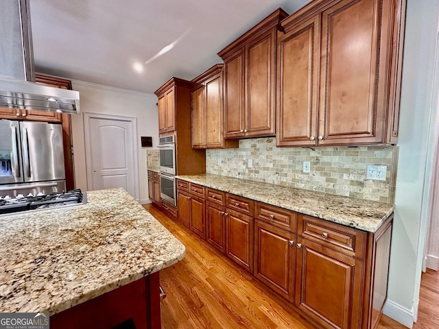 4265 Lansmoore, Suwanee, GA 30024 - kitchen with stainless steel appliances, light wood-style flooring, crown molding, and decorative backsplash