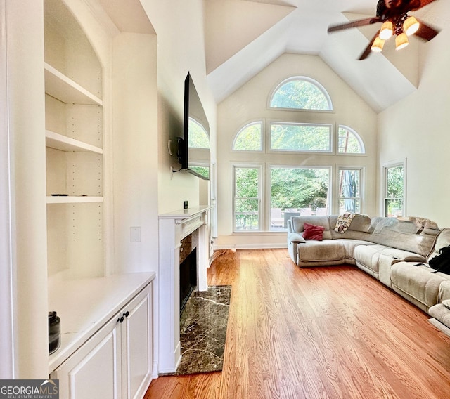 4265 Lansmoore, Suwanee, GA 30024 - living area with light wood-type flooring, a fireplace, ceiling fan, and high vaulted ceiling