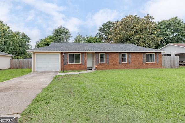 1027 Carl Vinson Pkwy, Centerville, GA 31028 - ranch-style house with driveway, an attached garage, brick siding, and roof with shingles