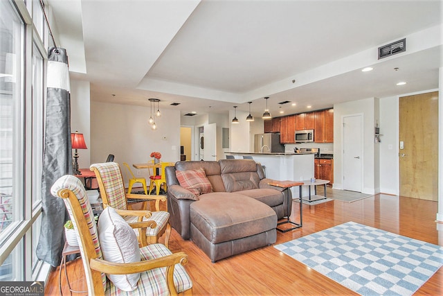 171 Auburn Ave NE Unit 521, Atlanta, GA 30303 - living room featuring light wood-style flooring, recessed lighting, and a raised ceiling