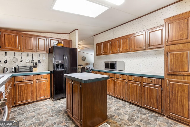 294 Birch Rd, Franklin, GA 30217 - kitchen with black fridge, stainless steel microwave, wallpapered walls, stone finish flooring, and brown cabinets