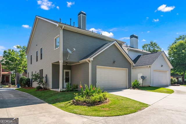 1666 Baxley Pine Trce, Suwanee, GA 30024 - view of side of property featuring a chimney, an attached garage, concrete driveway, and a yard
