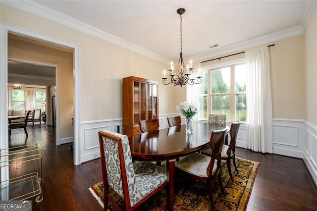 6110 Read Rd, Suwanee, GA 30024 - dining space with a chandelier, healthy amount of natural light, crown molding, wainscoting, and dark wood-style floors
