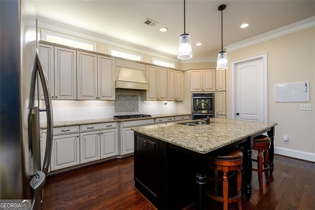 6110 Read Rd, Suwanee, GA 30024 - kitchen featuring stainless steel appliances, a sink, backsplash, a kitchen island with sink, and light stone counters