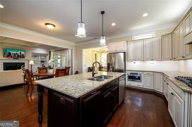 6110 Read Rd, Suwanee, GA 30024 - kitchen featuring a sink, appliances with stainless steel finishes, ornamental molding, dark wood finished floors, and an island with sink