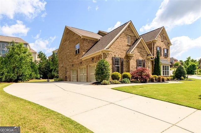 6110 Read Rd, Suwanee, GA 30024 - view of front facade featuring an attached garage, driveway, brick siding, and a front lawn