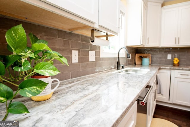 1032 Switchgrass Dr, Statham, GA 30666 - kitchen featuring a sink, white cabinetry, and decorative backsplash