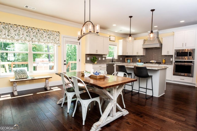 1032 Switchgrass Dr, Statham, GA 30666 - dining space featuring crown molding, dark wood-type flooring, and recessed lighting