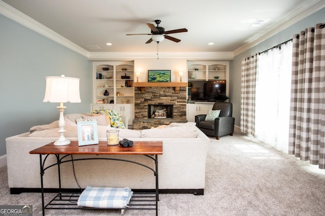 1032 Switchgrass Dr, Statham, GA 30666 - carpeted living area featuring a ceiling fan, crown molding, a stone fireplace, built in shelves, and baseboards