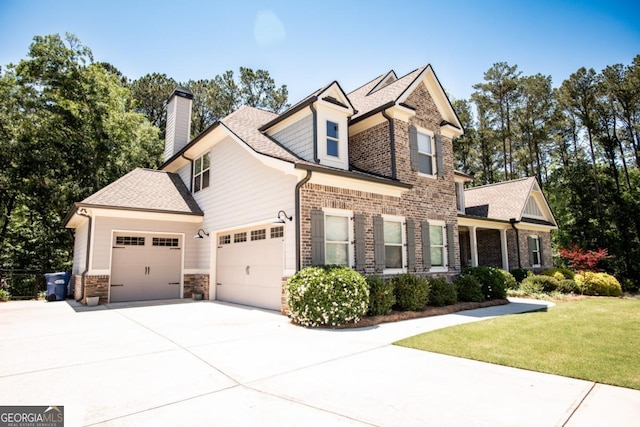 1032 Switchgrass Dr, Statham, GA 30666 - view of front facade with a front yard, an attached garage, concrete driveway, a chimney, and stone siding