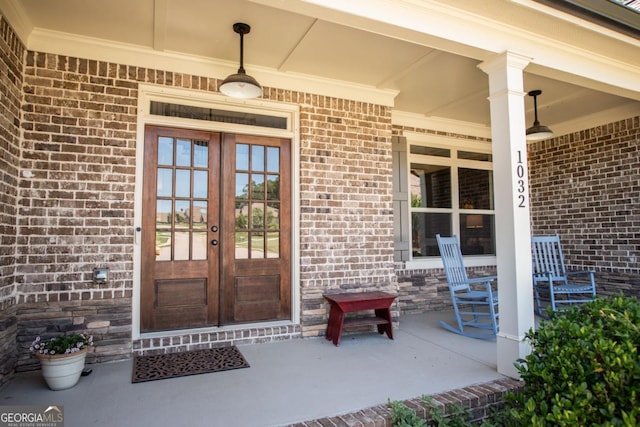 1032 Switchgrass Dr, Statham, GA 30666 - entrance to property with french doors, a porch, and brick siding